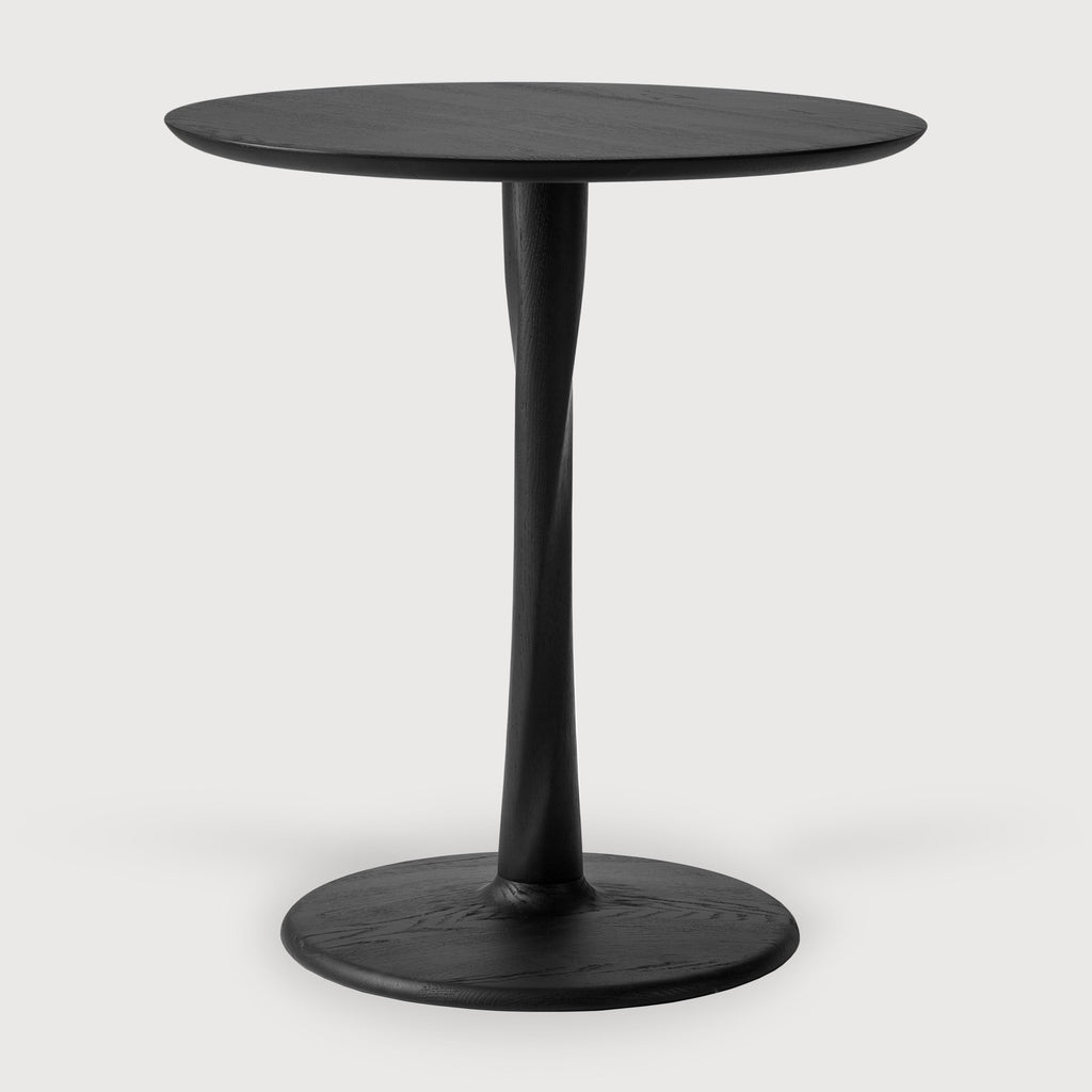 Black Oak Torsion Dining Table front angle with white background and a beautiful sculpted wood base. - Saffron and Poe, Ethnicraft