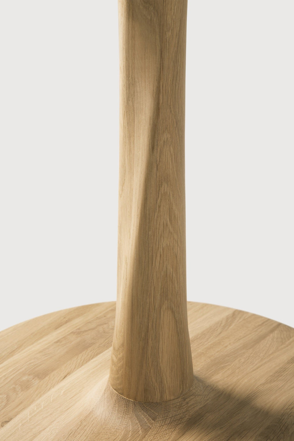 Torsion Dining Table in white oak with round top and sculptural twisted pedestal base