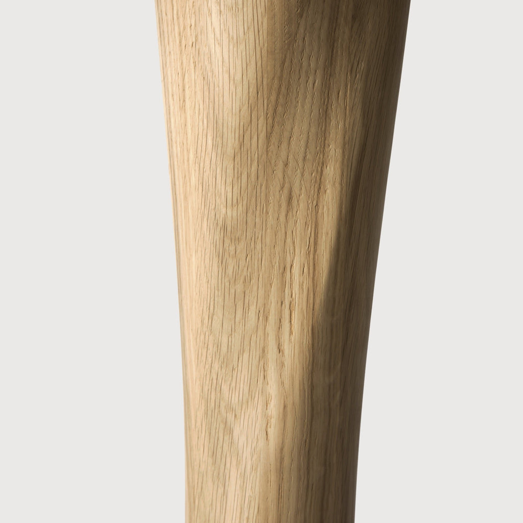 Torsion Dining Table in white oak with a round top and twisted sculptural pedestal base