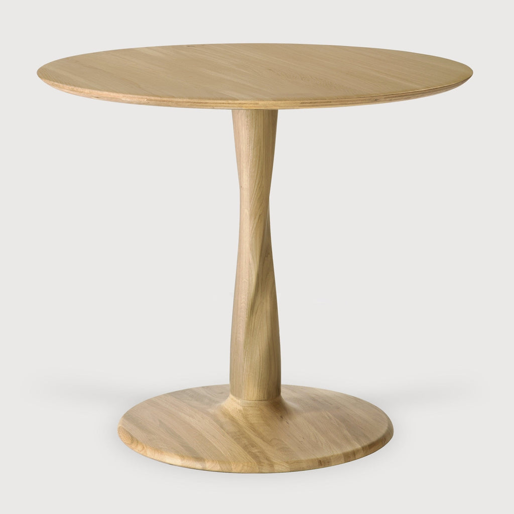 Torsion Dining Table with round white oak top and sculptural twisted pedestal base in modern dining room