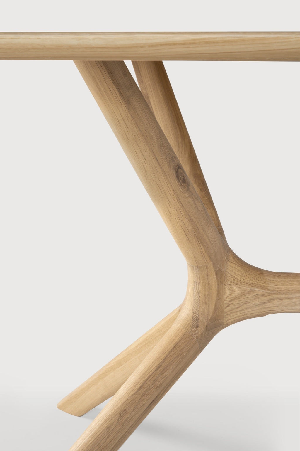 X Dining Table in premium European white oak with sleek contoured base and smooth tabletop
