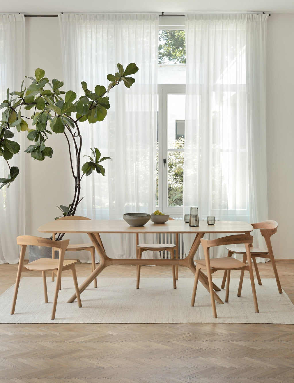 X Dining Table in white oak with contoured base and smooth tabletop design