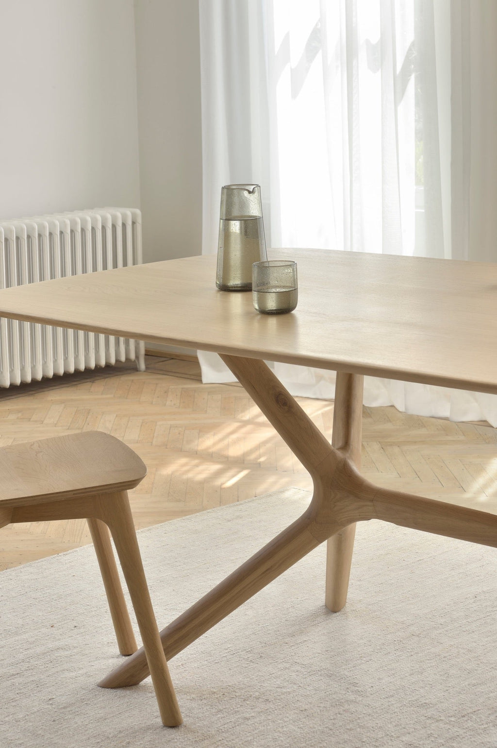 X Dining Table in white oak with contoured base and smooth tabletop, modern wooden dining furniture