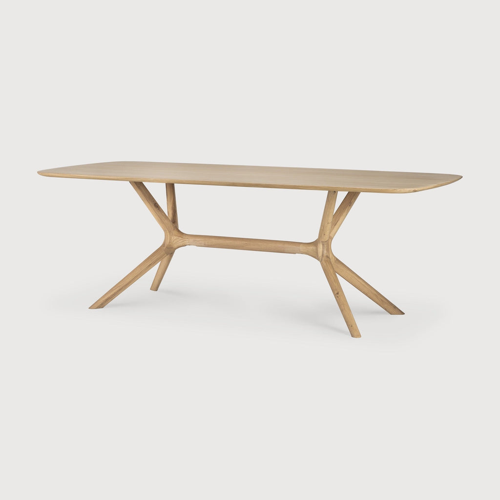 X Dining Table in white oak with contoured base and smooth tabletop design