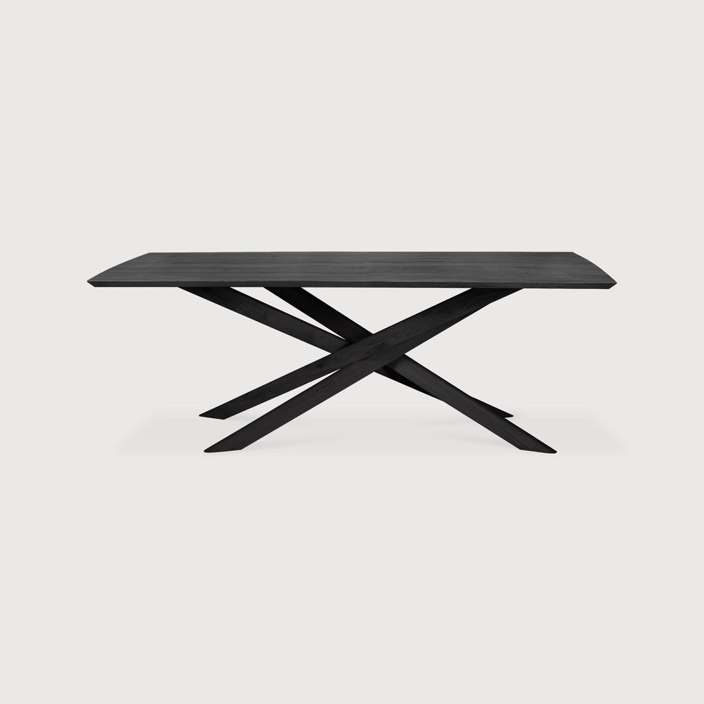Medium Black Oak Rectangle Mikado Dining Table detail with white background and beautiful intersecting wood legs. - Saffron and Poe, Ethnicraft