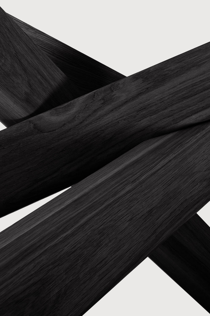 Black Oak Oval Mikado Dining Table detail with white background and beautiful intersecting wood legs. - Saffron and Poe, Ethnicraft