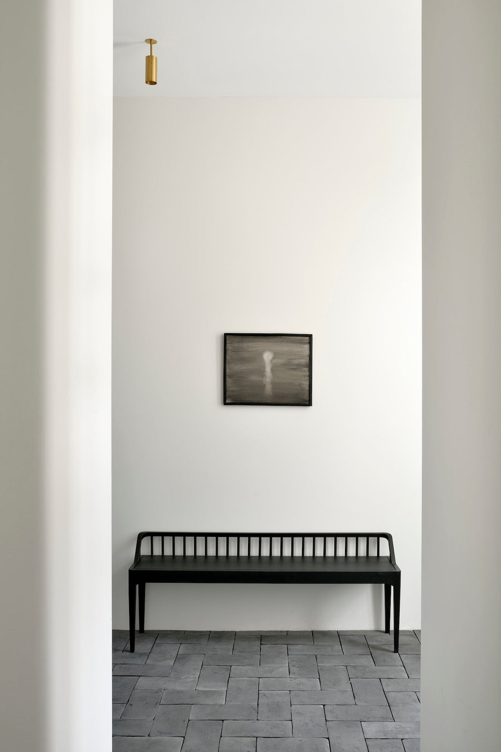 Black oak spindle bench with low spoked back and spacious seat in modern coastal design