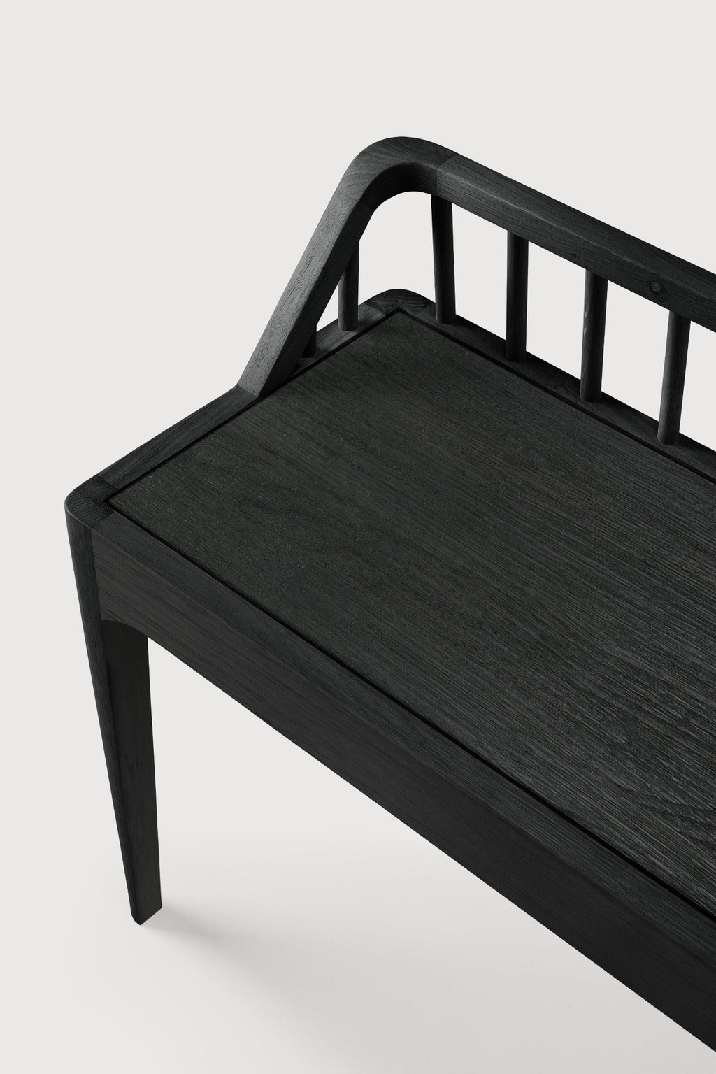 Black oak Spindle Bench with low spoked back and spacious seat, crafted from European white oak in coastal modern style