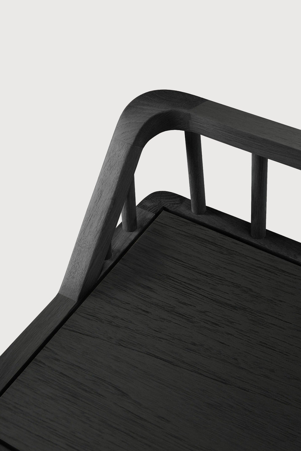 Black oak spindle bench with low spoked back and spacious seat in modern coastal style