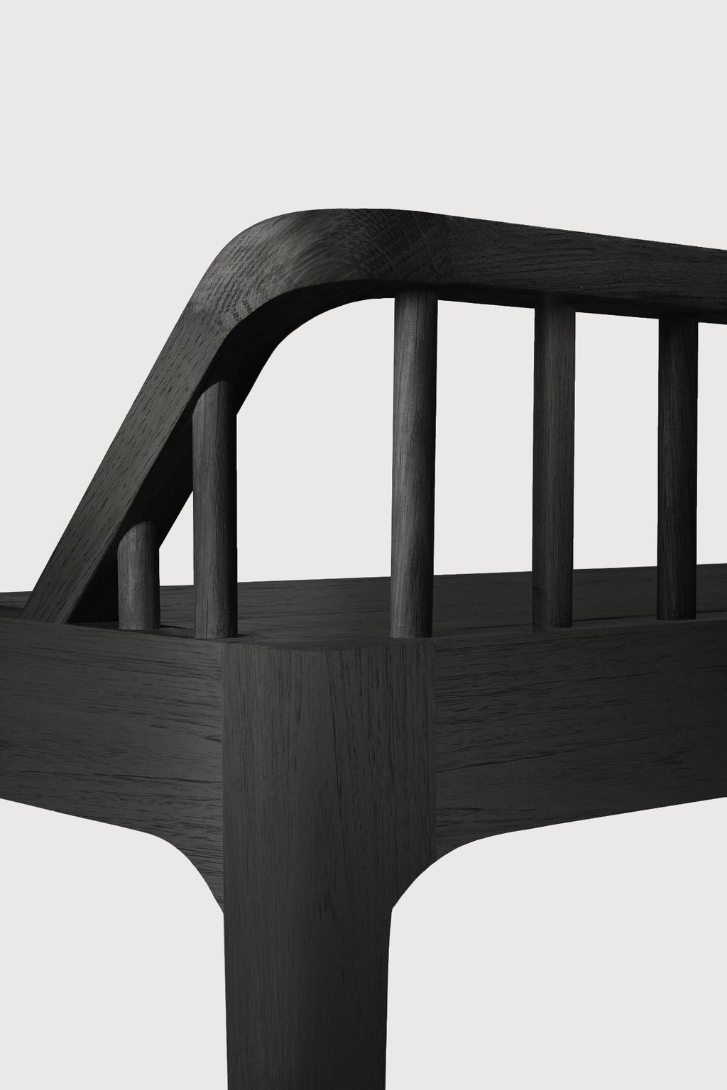 Black oak Spindle Bench with low spoked back and spacious seat in coastal modern style