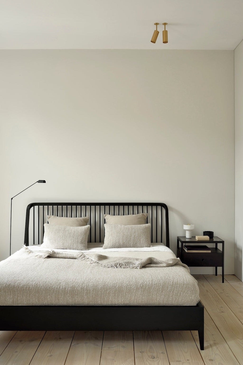 Black oak spindle bed with curved edges and classic headboard design