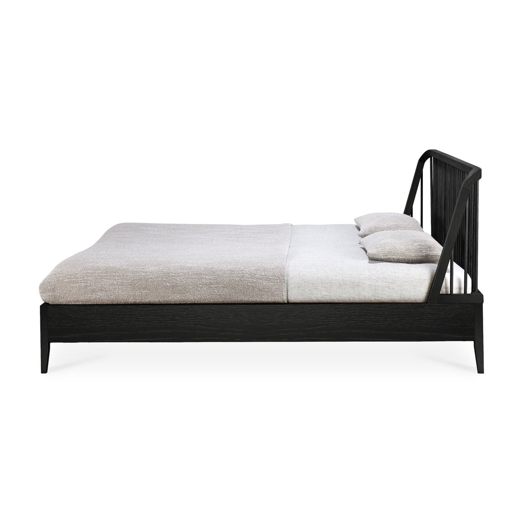 Black oak spindle bed with curved edges and classic coastal design