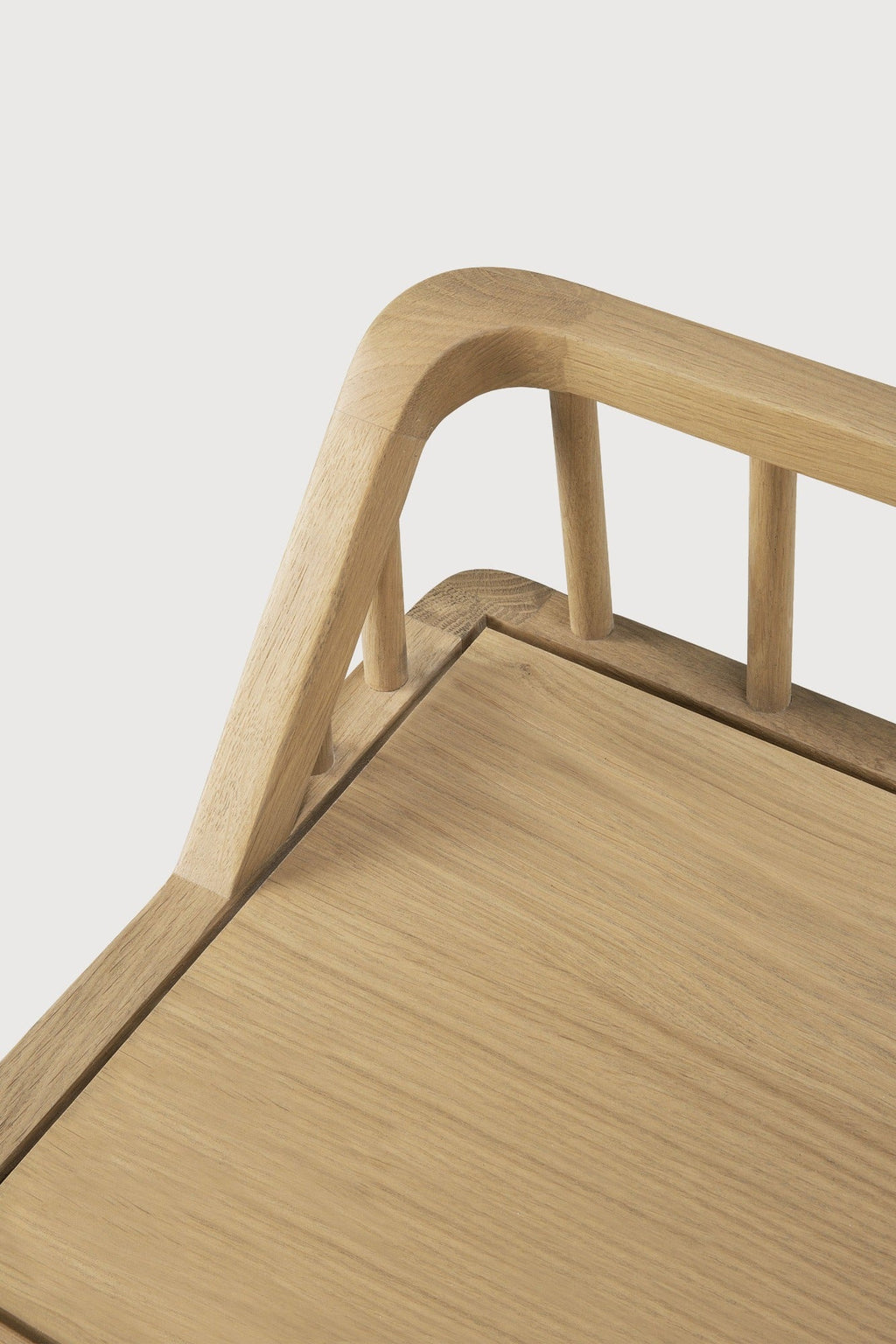 White oak spindle bench with low spoked back and spacious seat in coastal modern style