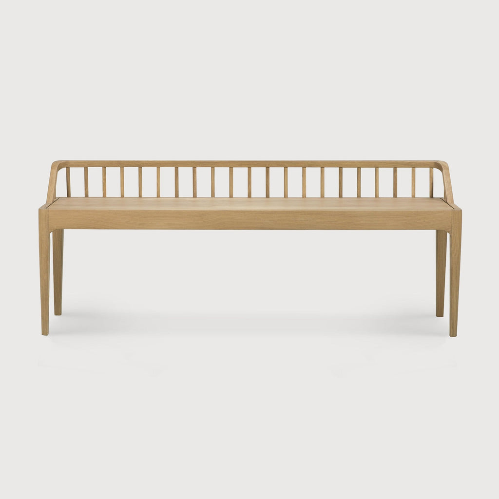 White oak Spindle Bench with low spoked back and spacious seat in coastal modern style