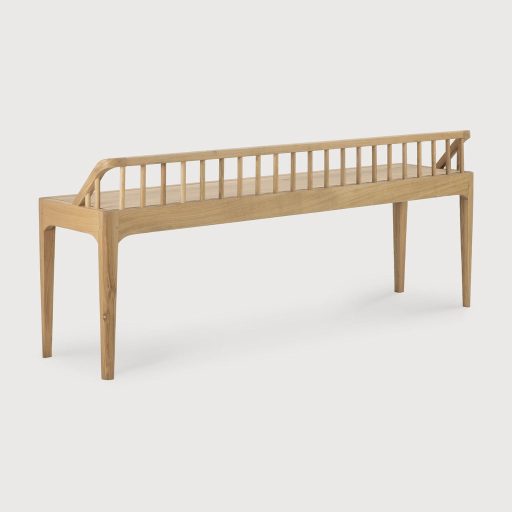 White oak Spindle Bench with low spoked back and spacious seat in modern coastal design