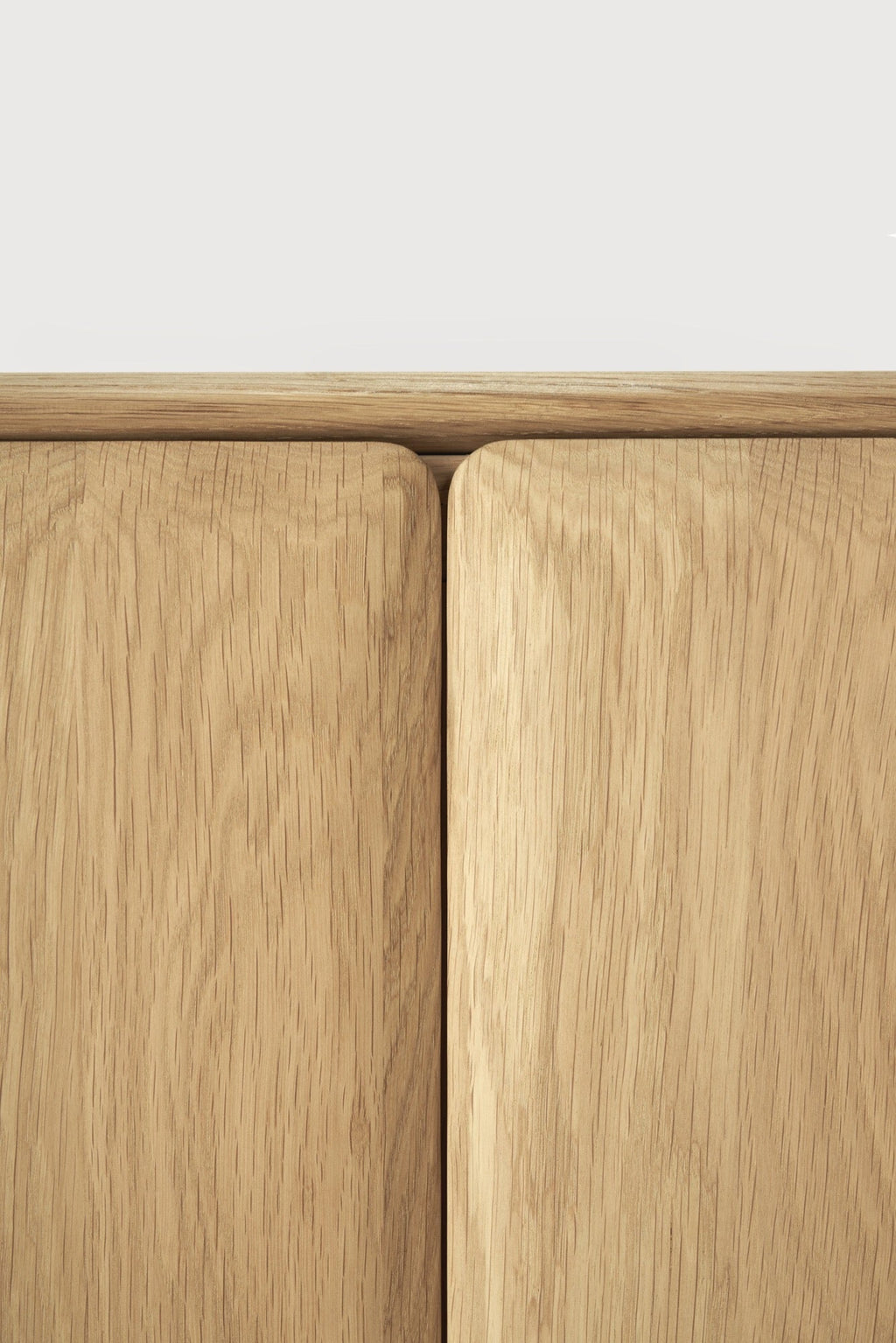 PI Sideboard in white oak with modern silhouette, sculpted base, and curved edges for stylish storage