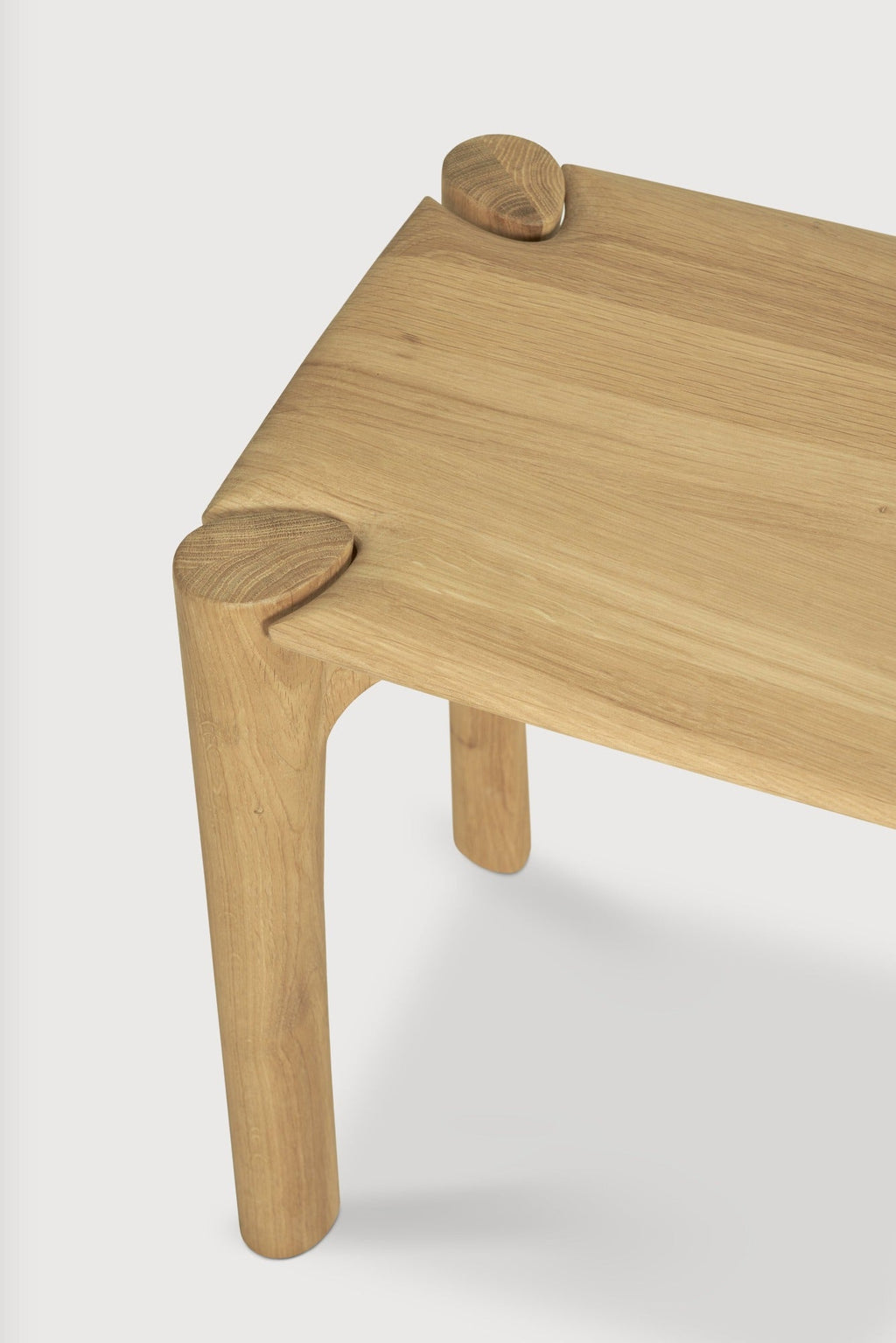 PI Bench in solid white oak with sculpted base and curved edges, modern design