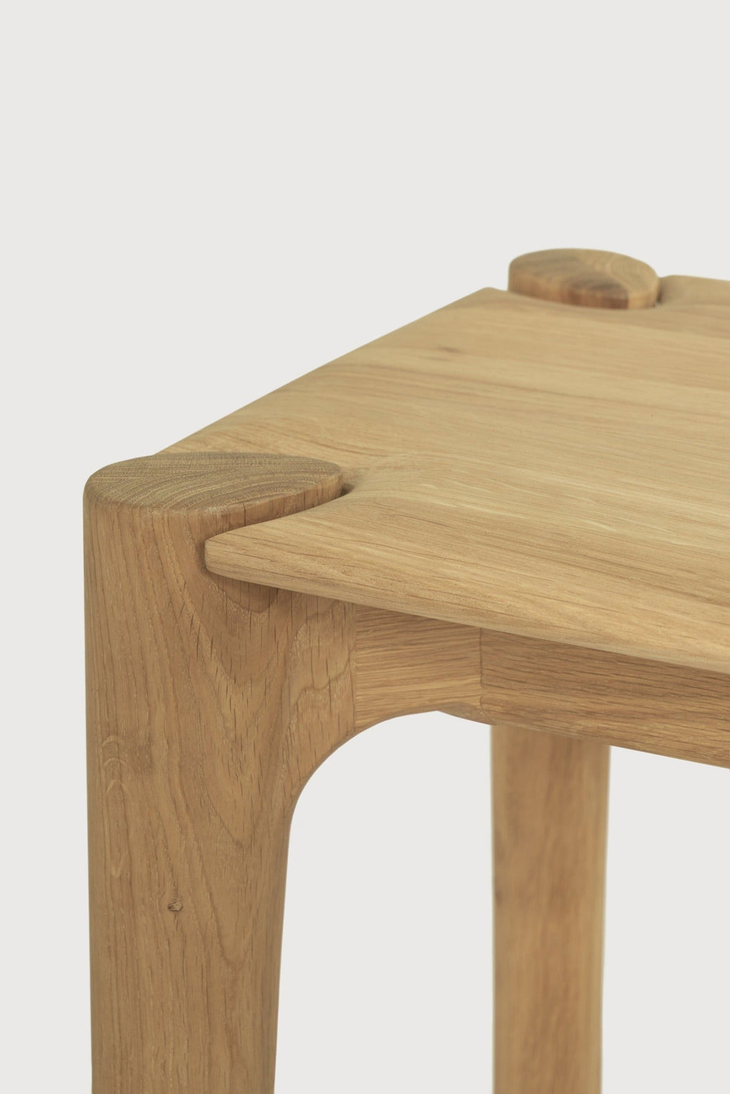 PI Bench in white oak with sculpted base and curved edges, modern silhouette and polished organic finish