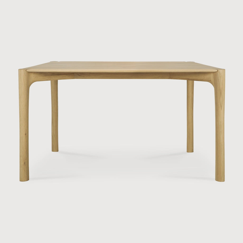 PI Dining Table in white oak with sculpted base and curved edges, featuring a polished organic finish