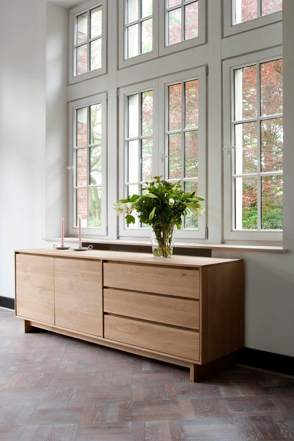 Wave Sideboard in white oak with graceful contours and handle-free doors