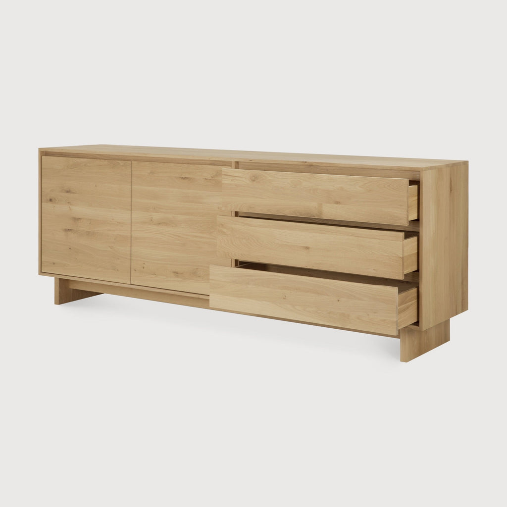 Wave Sideboard in white oak with graceful contours, handle-free doors, and ample storage