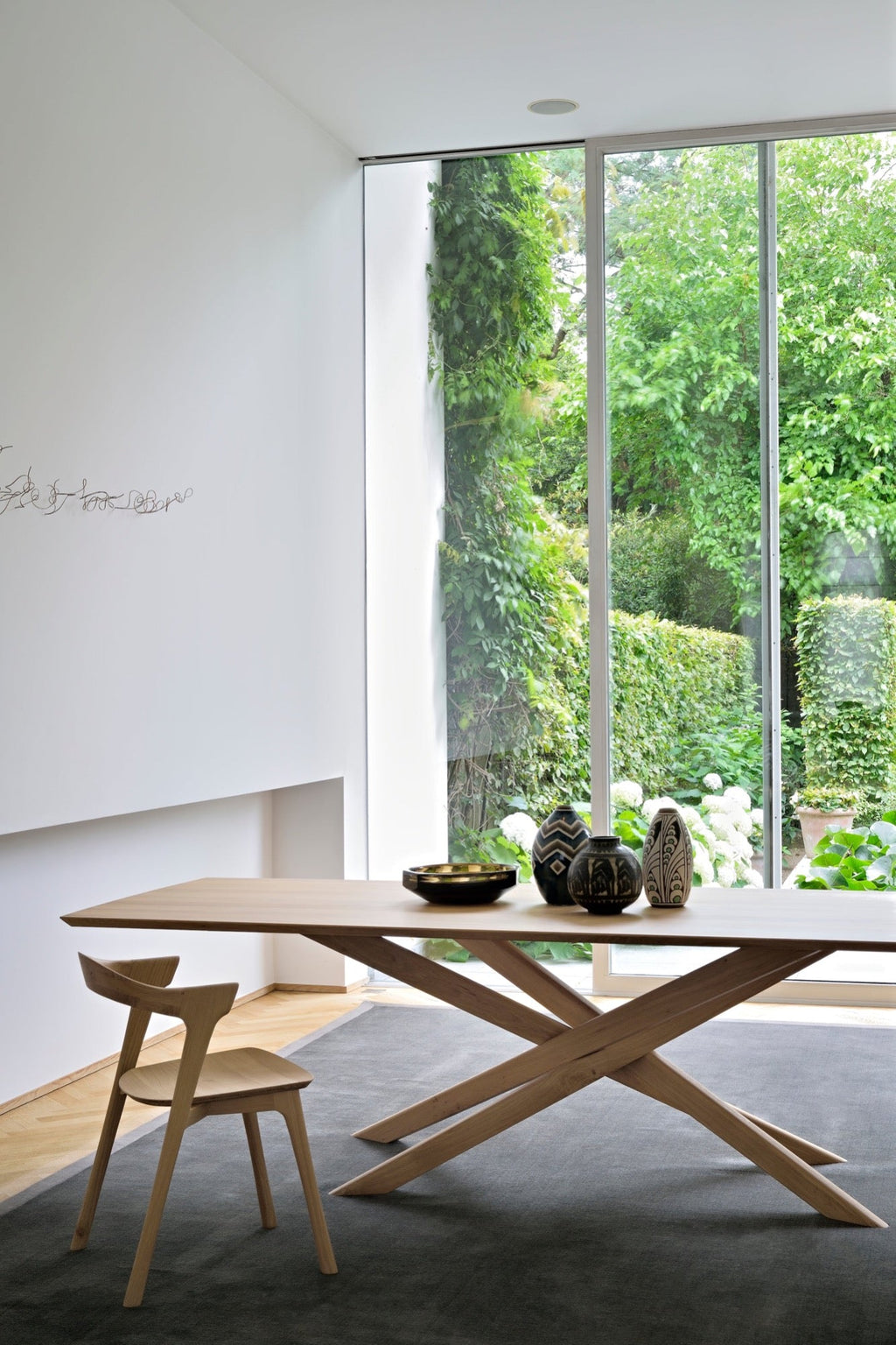 Mikado Dining Table made of white oak with sculptural interlocking legs and oiled finish