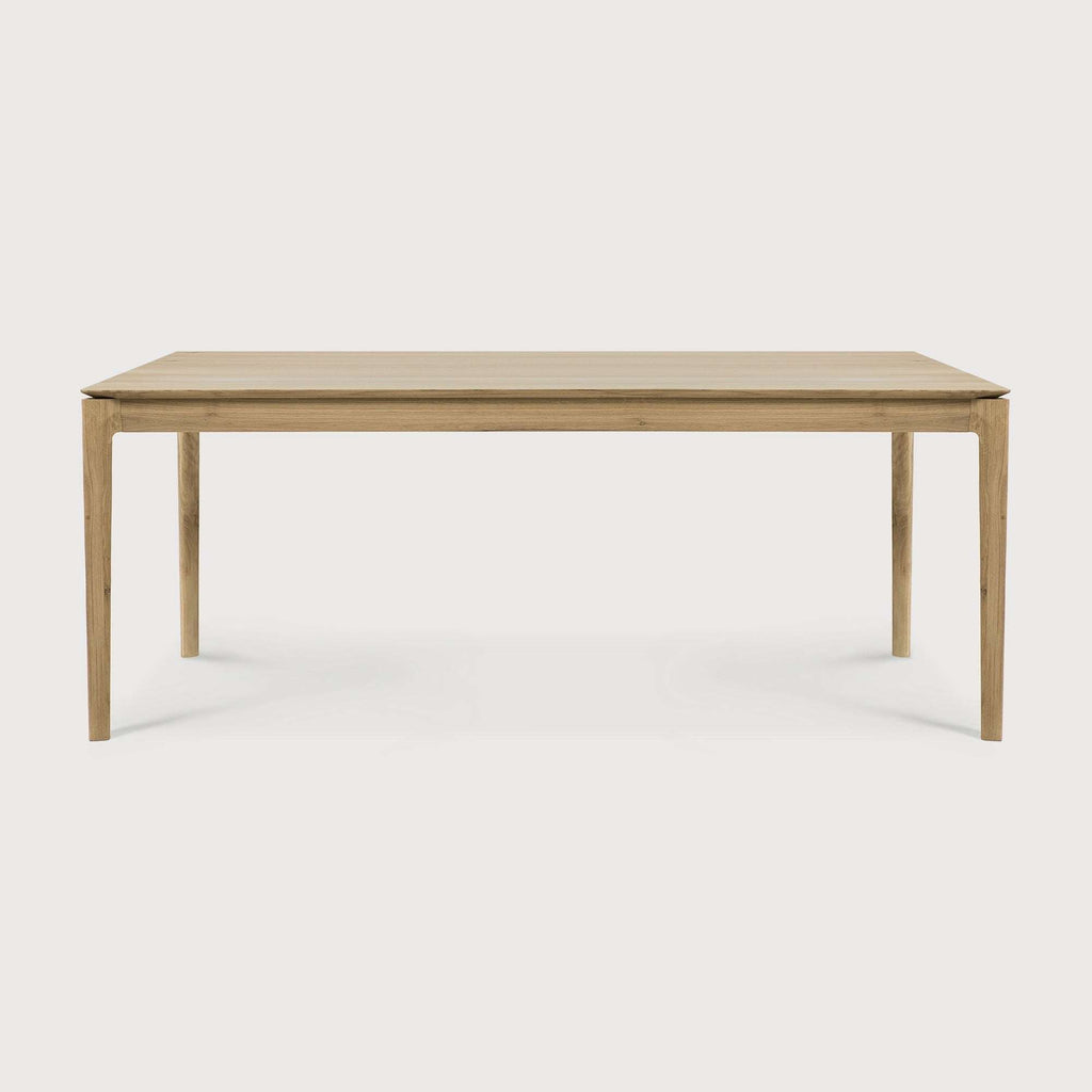 Bok Dining Table in white oak with contoured frame and floating top, showcasing timeless design and solid construction