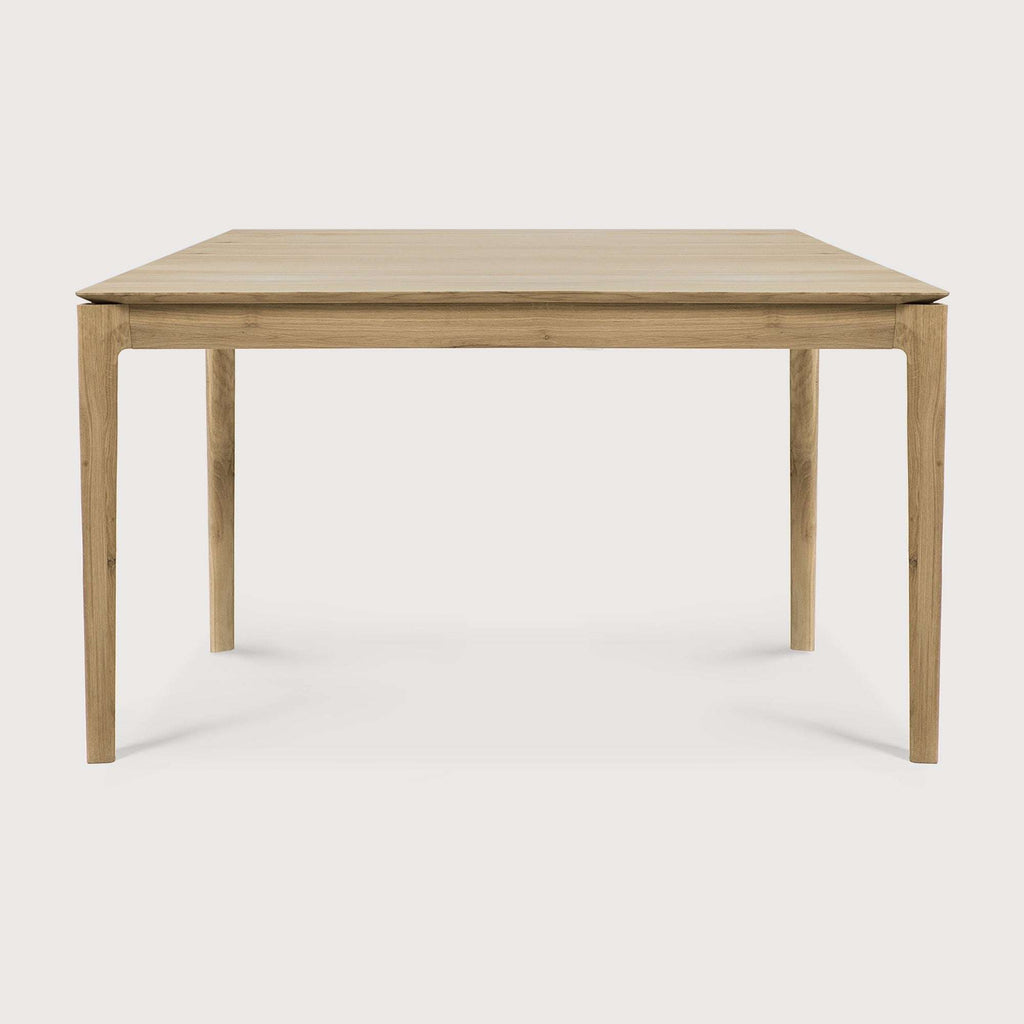 Bok Dining Table in white oak with floating top and contoured frame, showcasing timeless design and sturdy construction.
