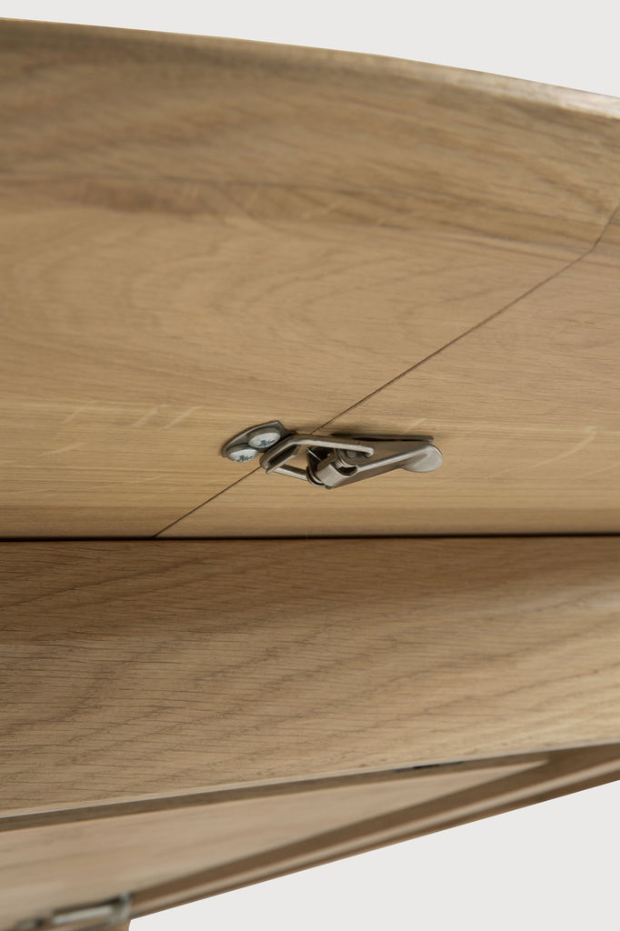 Oak Bok Round Extendable Dining Table close up detail of underside showing extension latch with white background. - Saffron and Poe, Ethnicraft