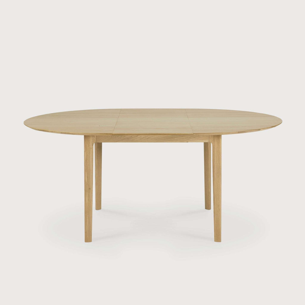 Bok extendable round dining table in white oak with floating top and contoured frame