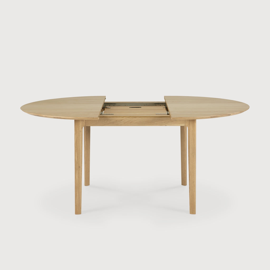Oak Bok Round Extendable Dining Table side view featuring extension mechanism with white background, featuring floating table top and beautiful wood joinery. - Saffron and Poe, Ethnicraft