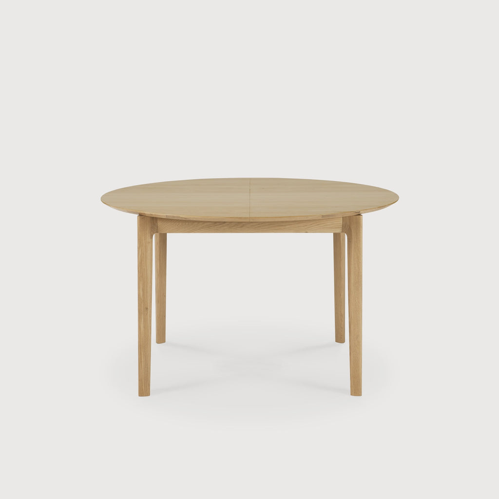 Oak Bok Round Extendable Dining Table side view in small closed position with white background, featuring floating table top and beautiful wood joinery. - Saffron and Poe, Ethnicraft