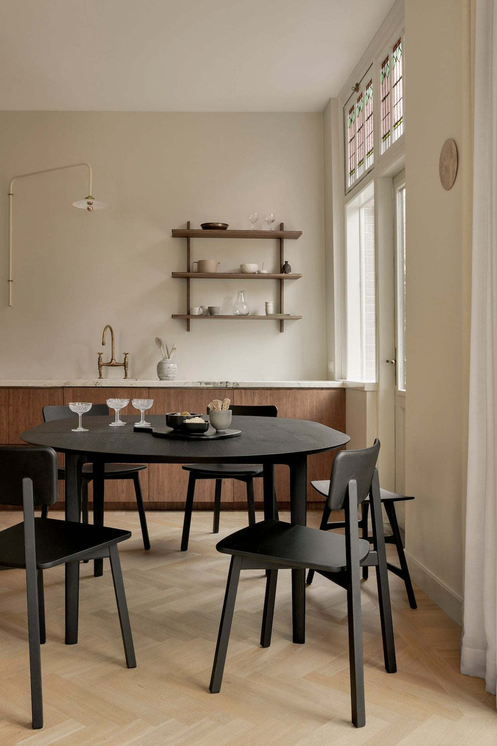 Bok extendable round dining table in black oak with floating top and contoured frame