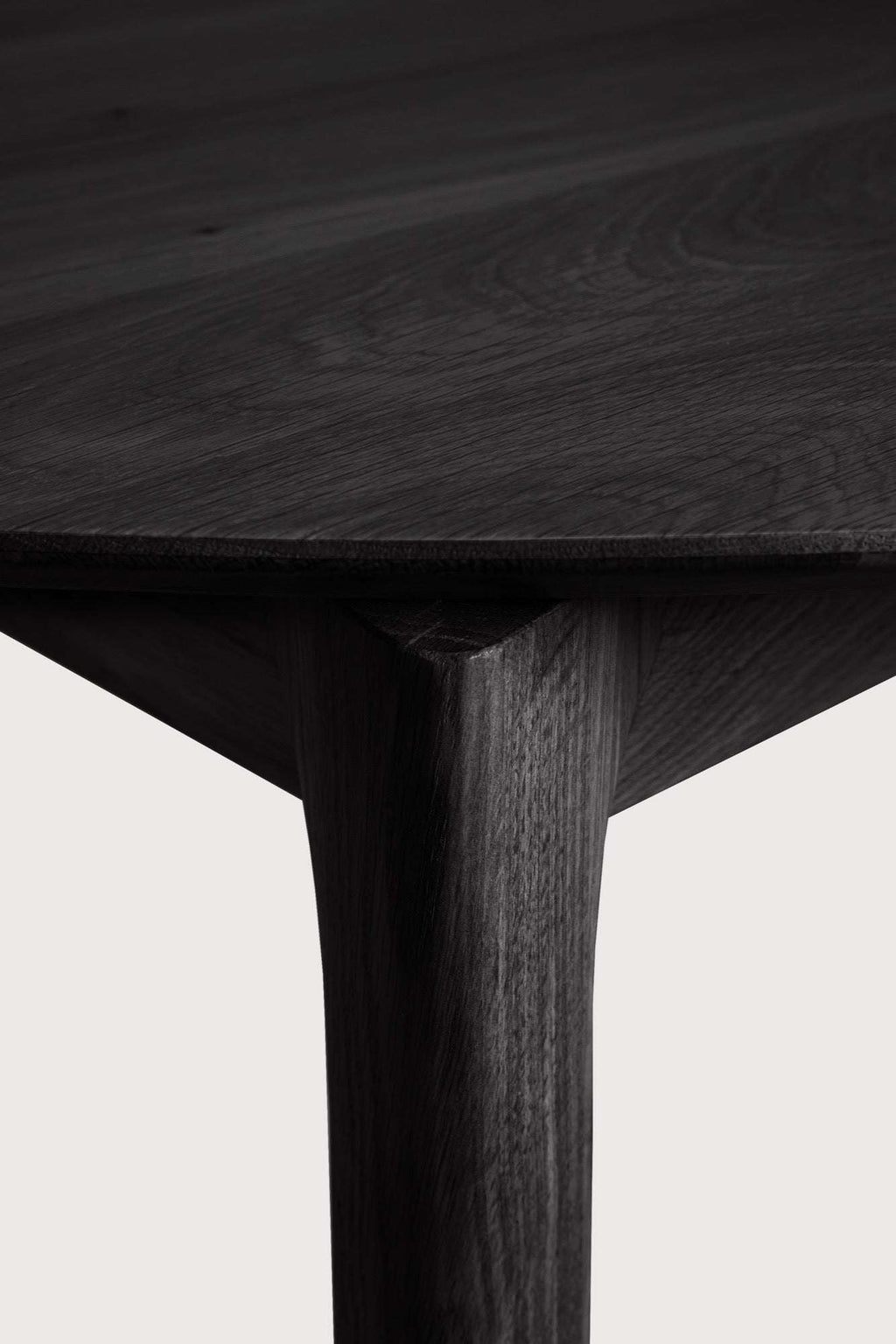 Bok Extendable Round Dining Table in black oak with floating top and contoured frame
