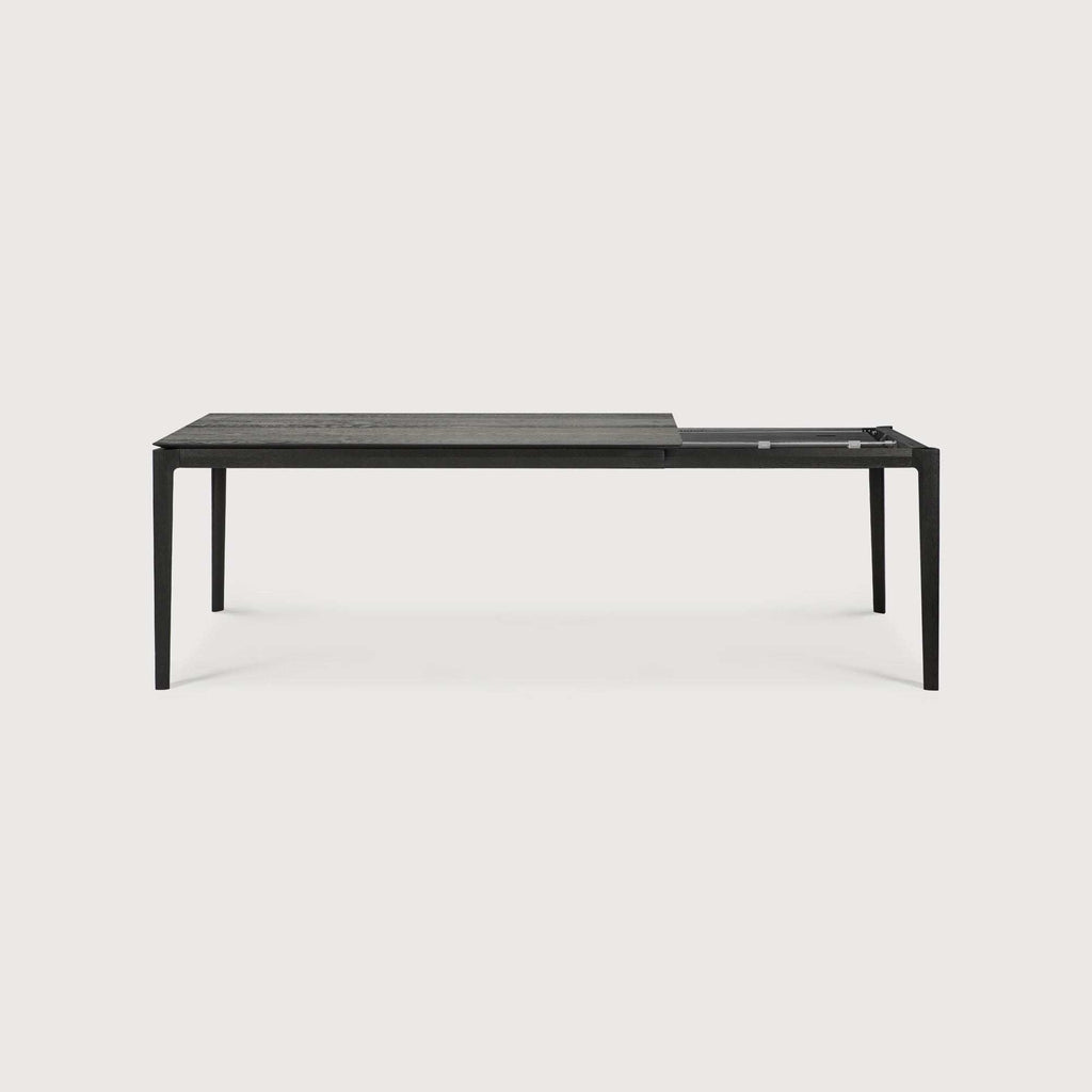 Bok Extendable Dining Table in black oak with sleek contoured frame and floating top
