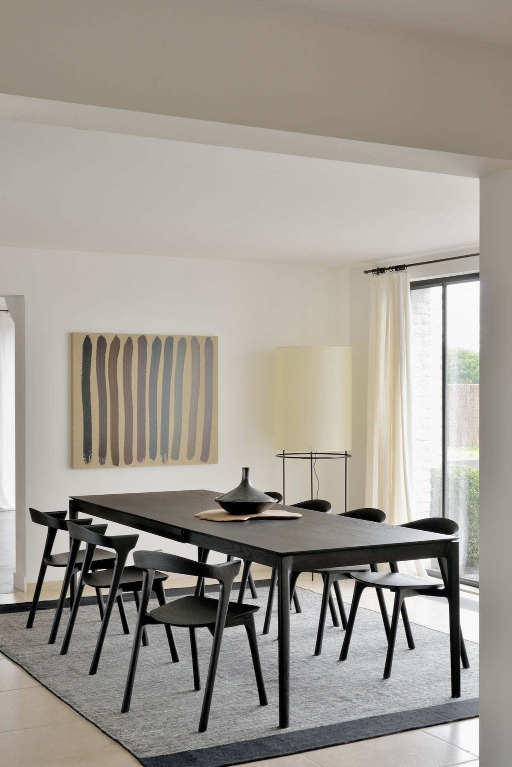 Bok Extendable Dining Table in black oak with floating top and contoured frame