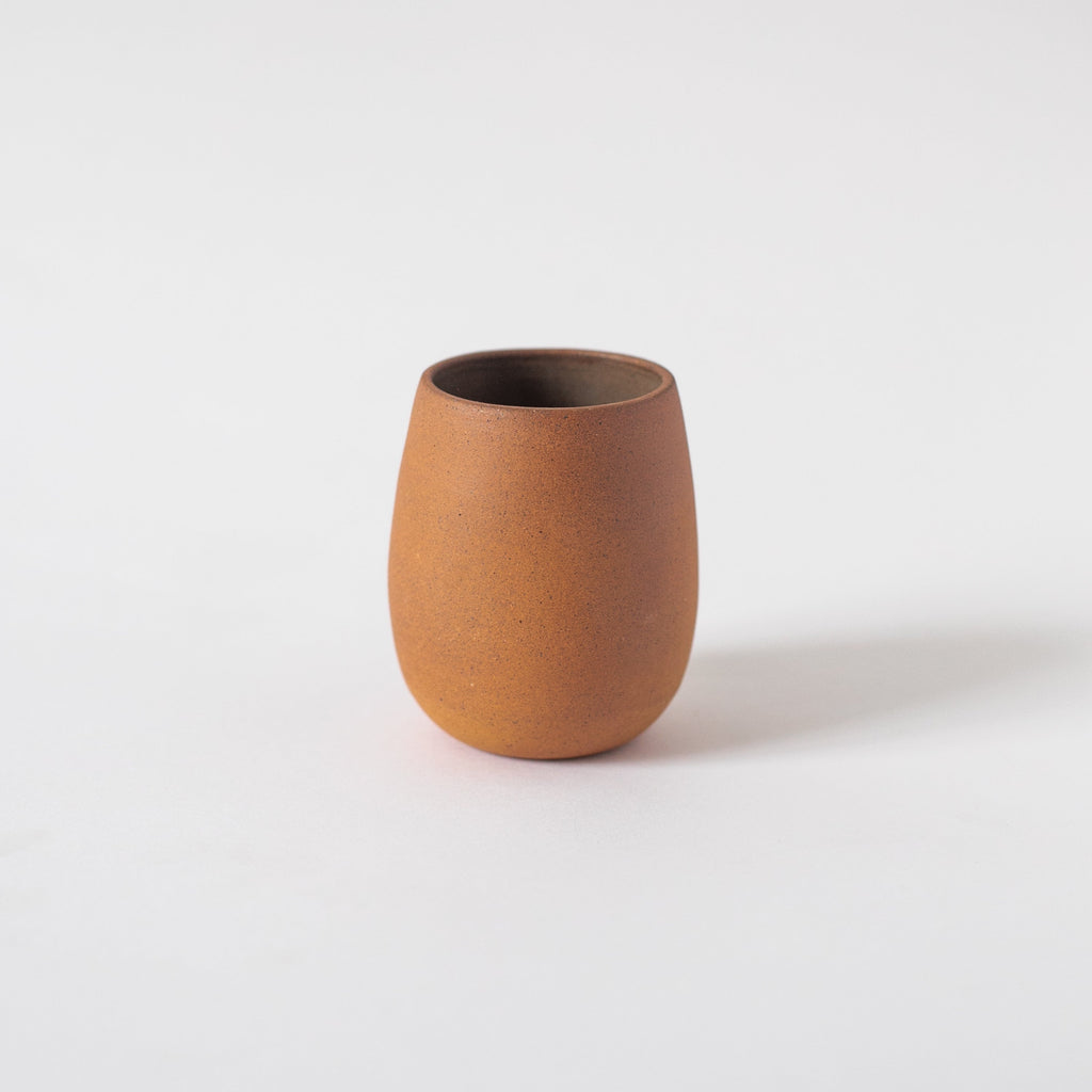 Handcrafted 10 oz ceramic Bola Cup with earth-toned textured glaze inside, made from local clays fired in kiln