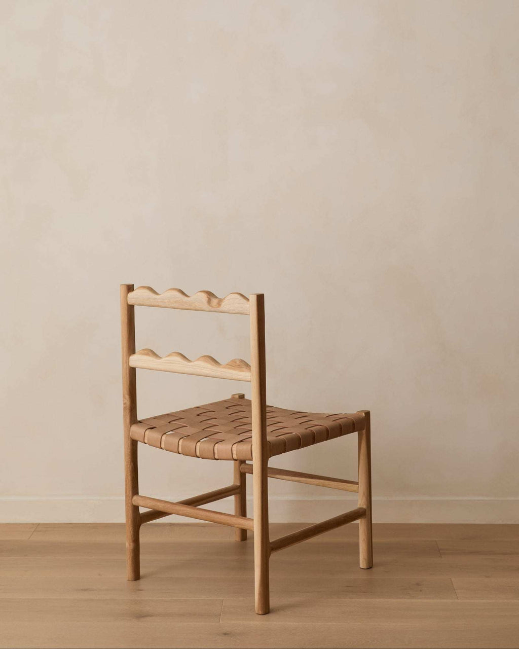 Aegean Scalloped Dining Chair handcrafted from teak wood with woven leather seat and scalloped backrest