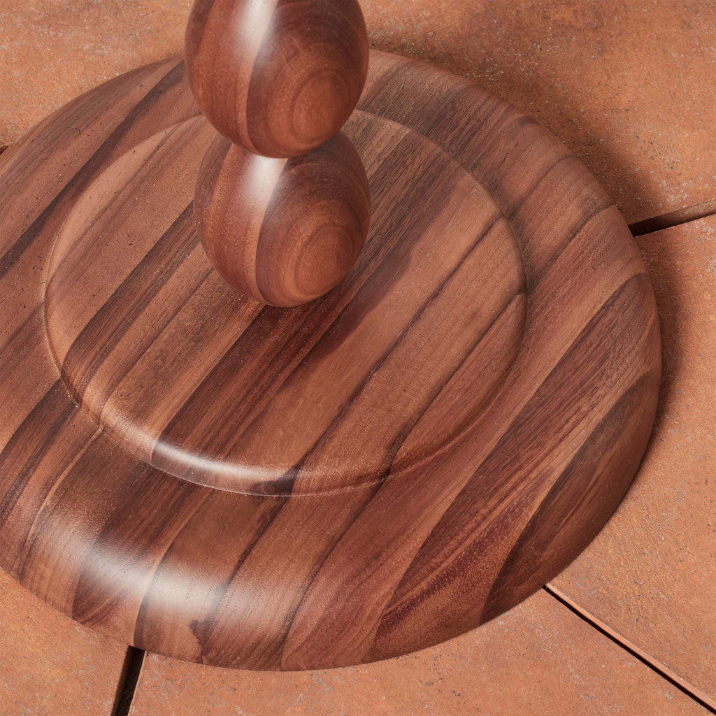 Wooden base of Alhambra floor lamp on a brown surface