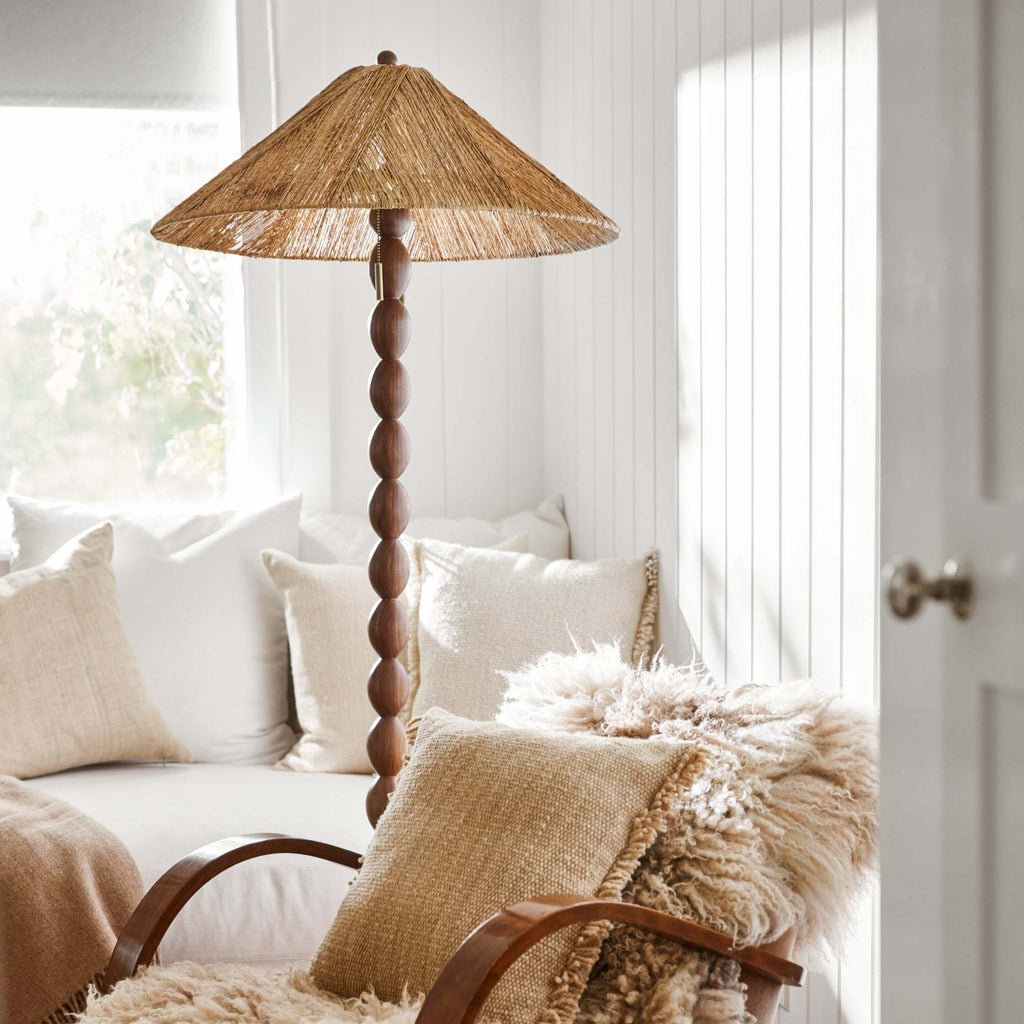 Decorative Alhambra Floor lamp with wicker shade in a cozy living room setting.