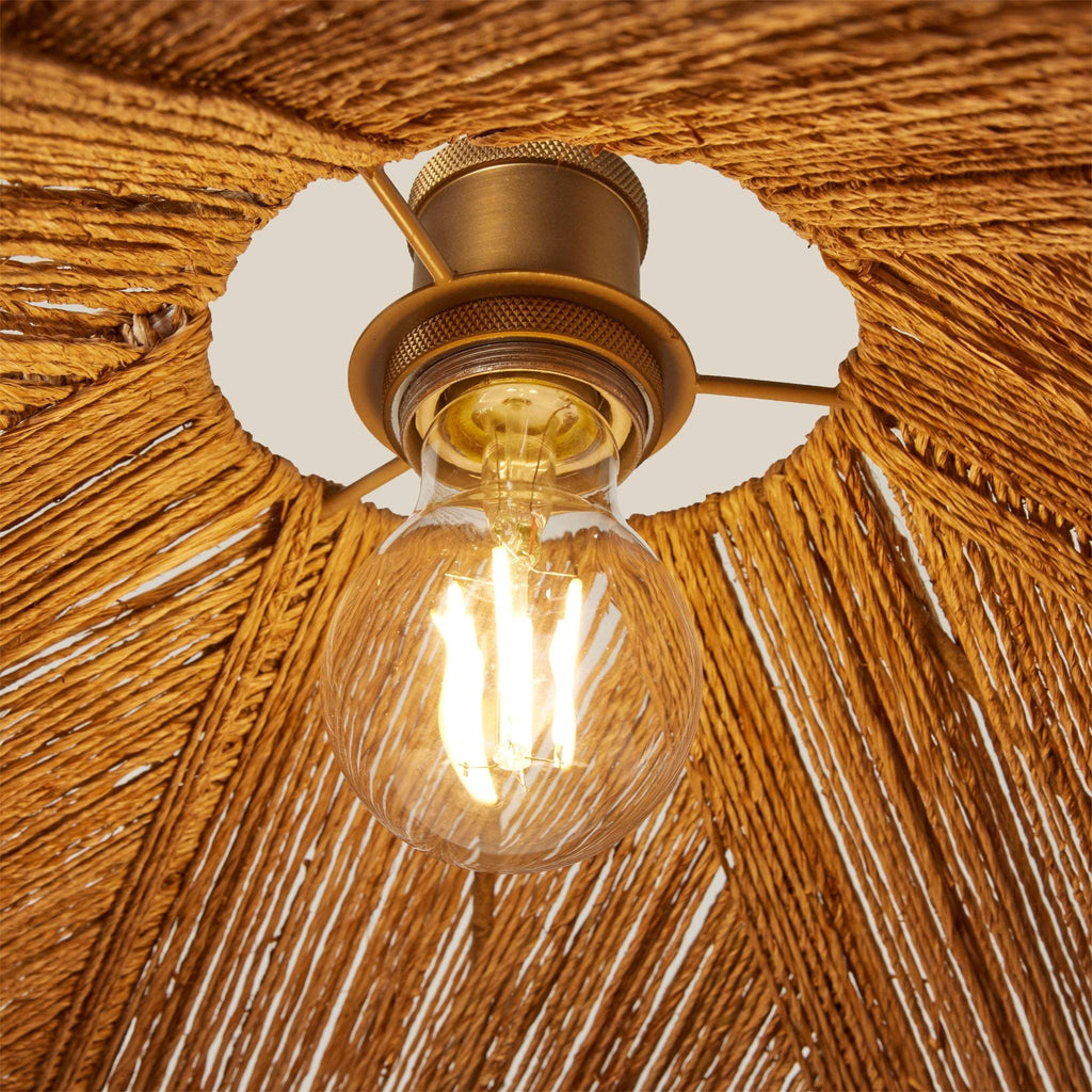 Vintage-style light bulb in a Alhambra pendant against a wooden background