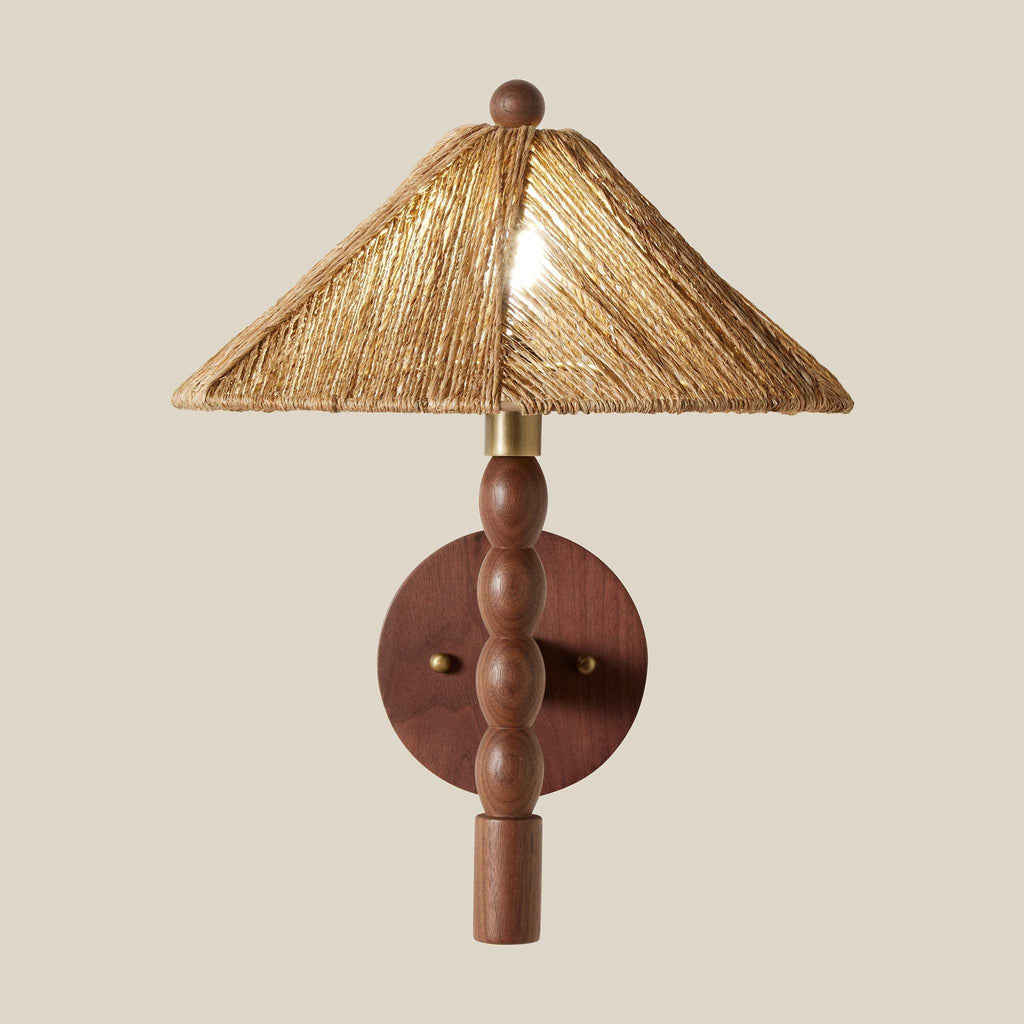 Wooden Alhambra wall sconce with a straw-like lampshade on a beige background
