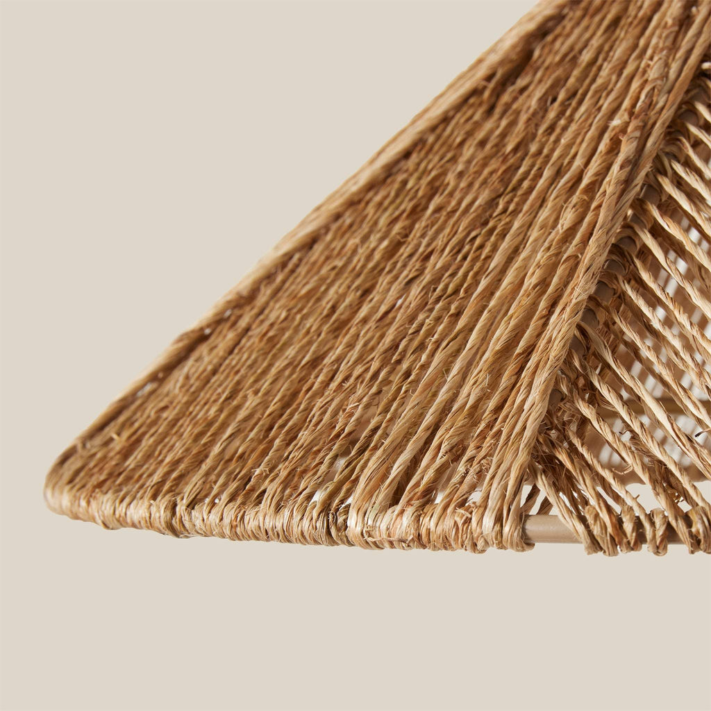 Close-up of a woven lampshade of an Alhambra sconce on a beige background
