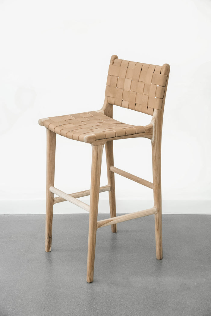 Side profile of our comfortable, casual, Woven leather strap bar stool in beige. Handmade in Bali using Teak wood and vegetable-tanned leather imported from Java. - Saffron and Poe