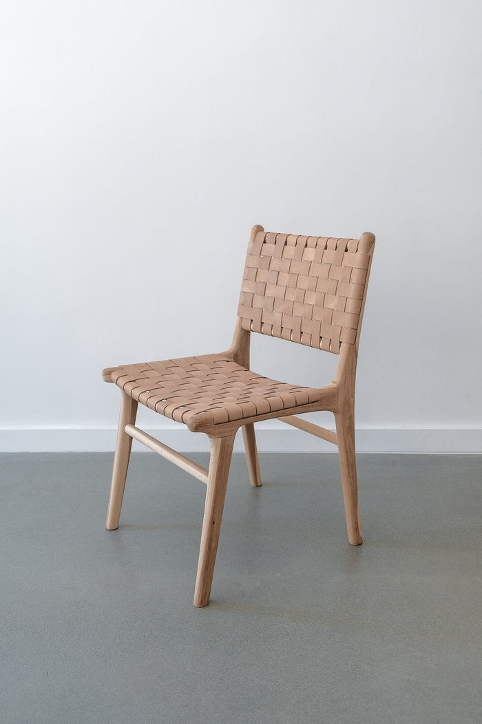Woven Leather Strap Dining Chair - Beige - Saffron + Poe simple beige neutral chair against white wall Handmade in Bali using Teak wood and vegetable-tanned leather imported from Java.
