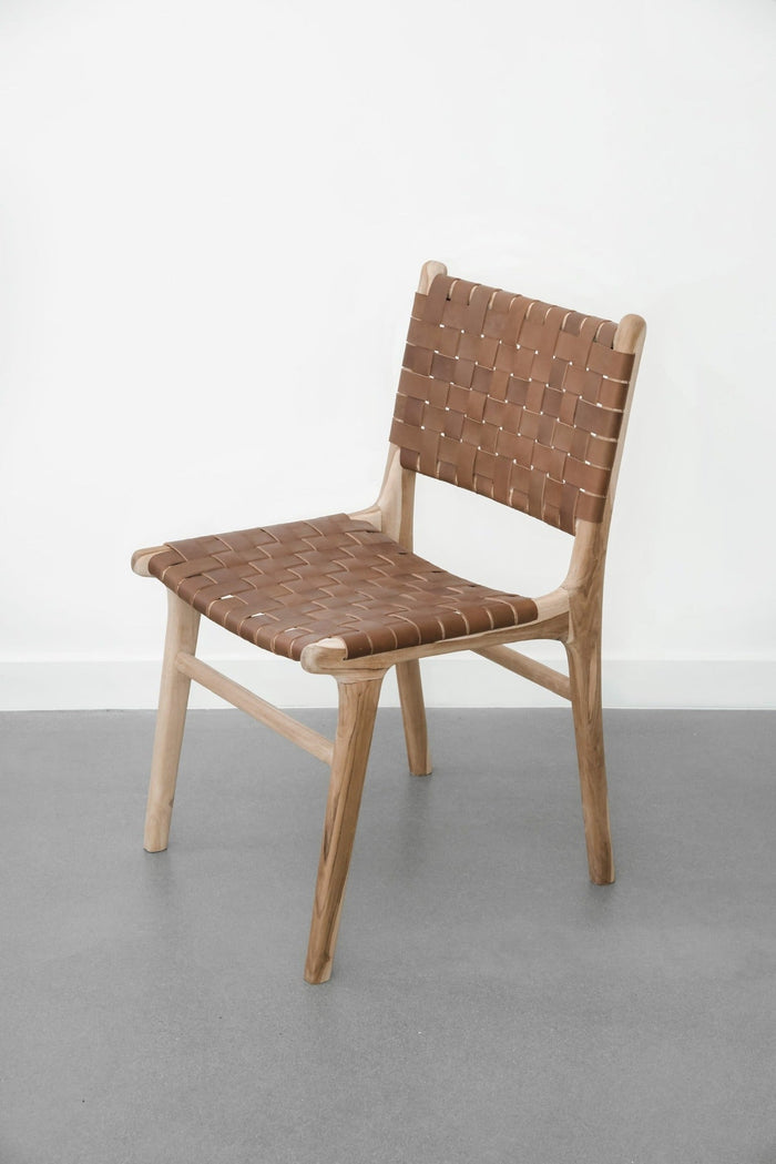 White background with our Woven Leather Strap Dining Chair - Saddle. Handmade in Bali with Teak wood and vegetable-tanned leather imported from Java. - Saffron and Poe