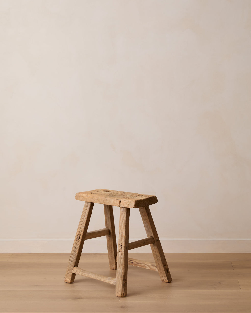 Antique elmwood stool handcrafted in China with worn patina and traditional joinery