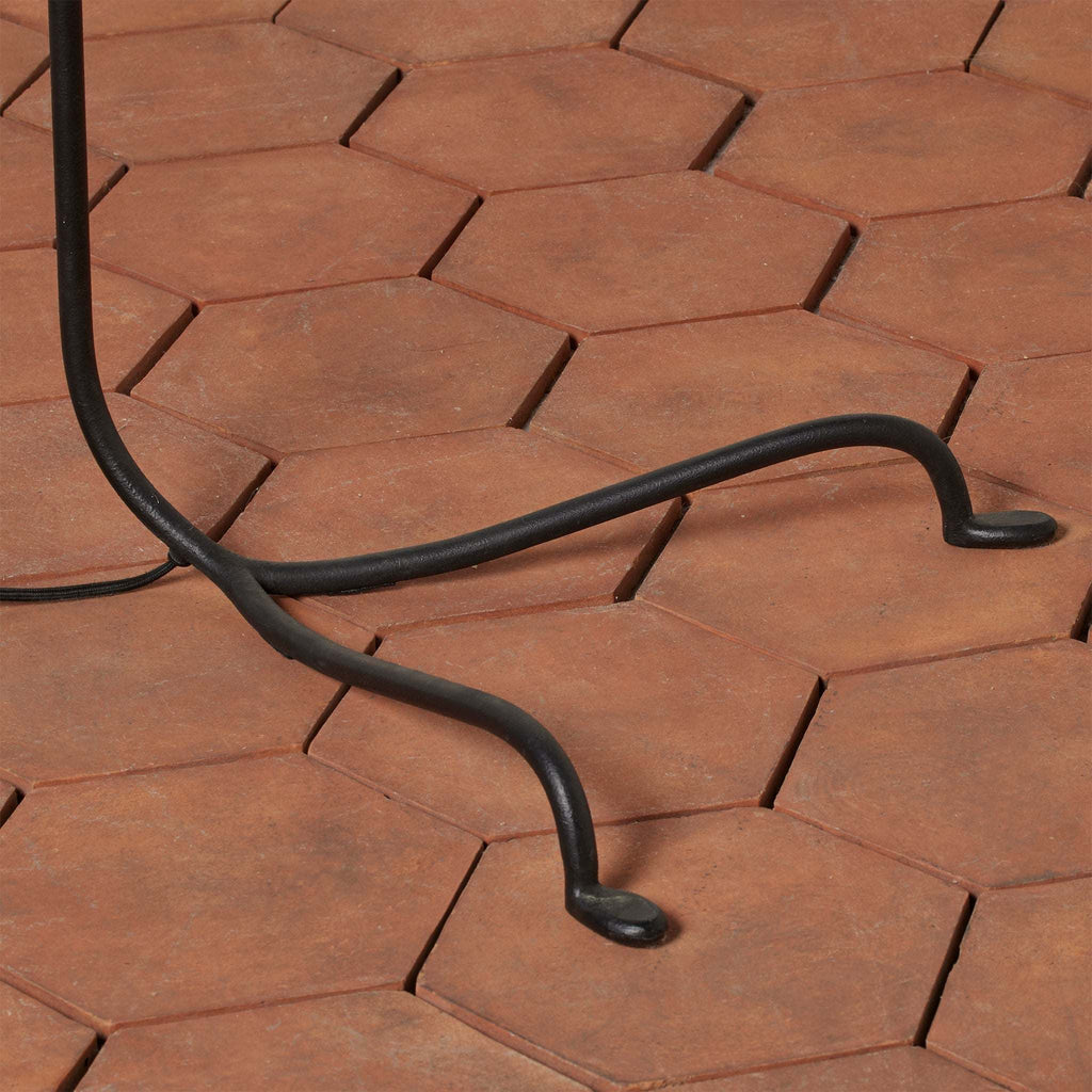 Black metal Bainbridge lamp stand on a hexagonal stone pavement