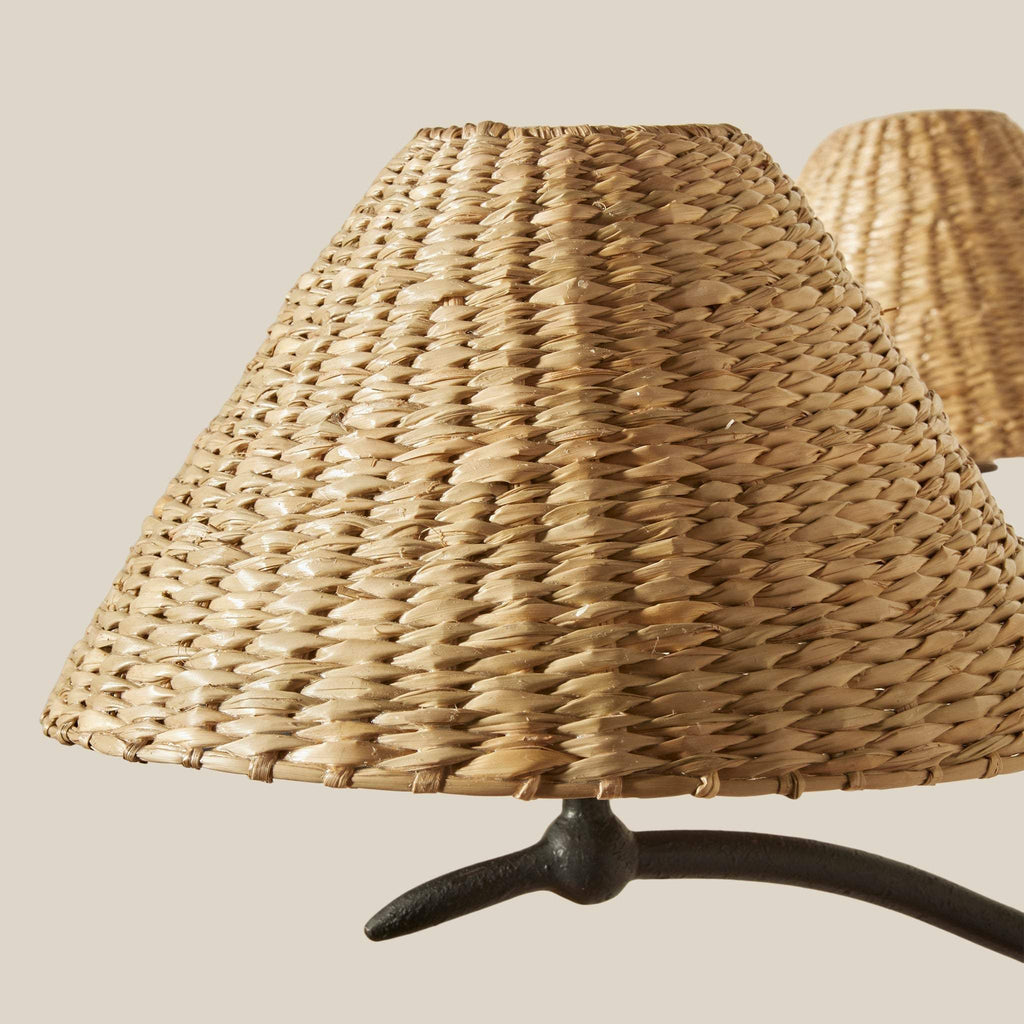 Wicker lampshade of the Bainbridge Large Chandelier on a stand against a neutral background