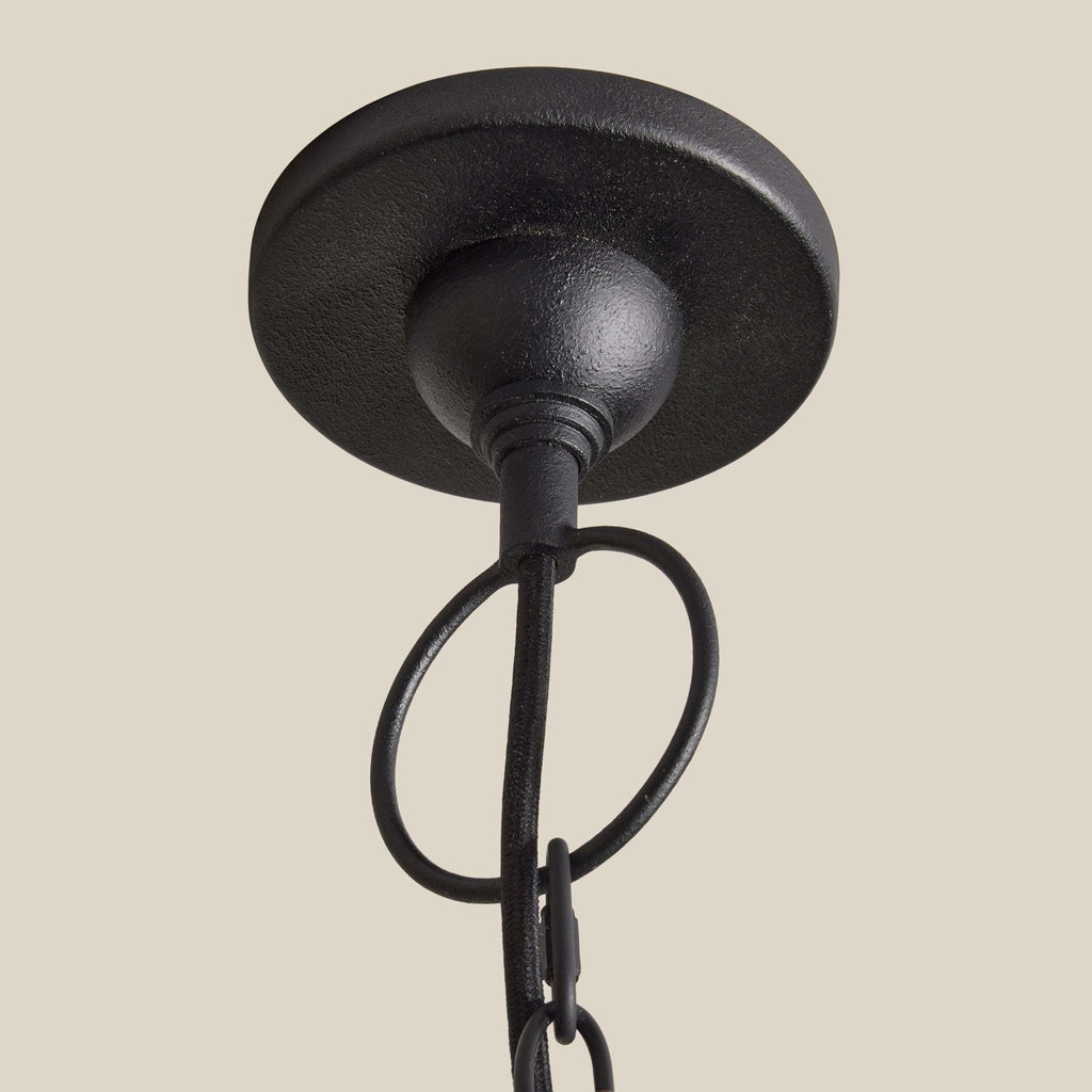 Black metal ceiling fixture on a beige background